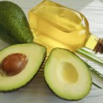 avocado-oil-in-jar-next-to-halved-avocado
